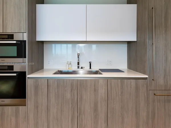 a kitchen with a sink and cabinets
