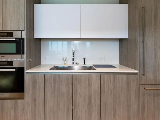 a kitchen with a sink and cabinets