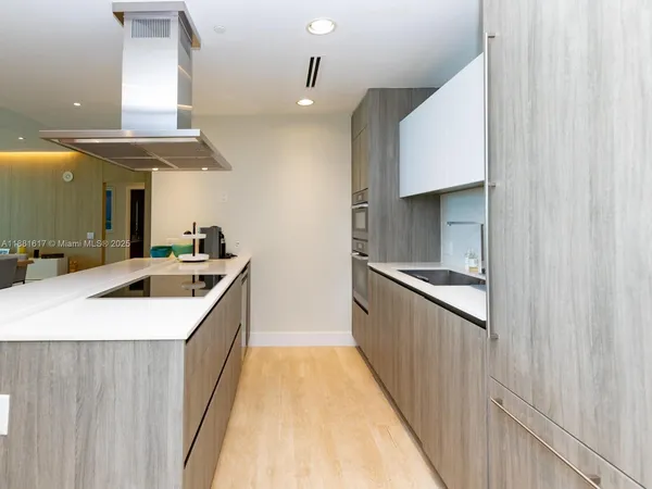 a bathroom with a sink a large mirror and a shower