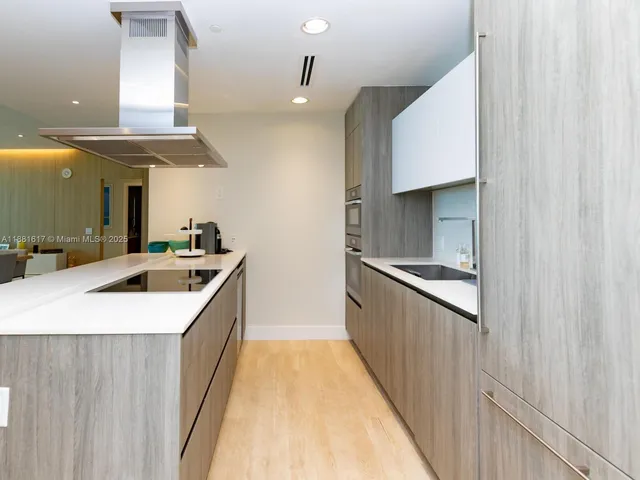 a bathroom with a sink a large mirror and a shower