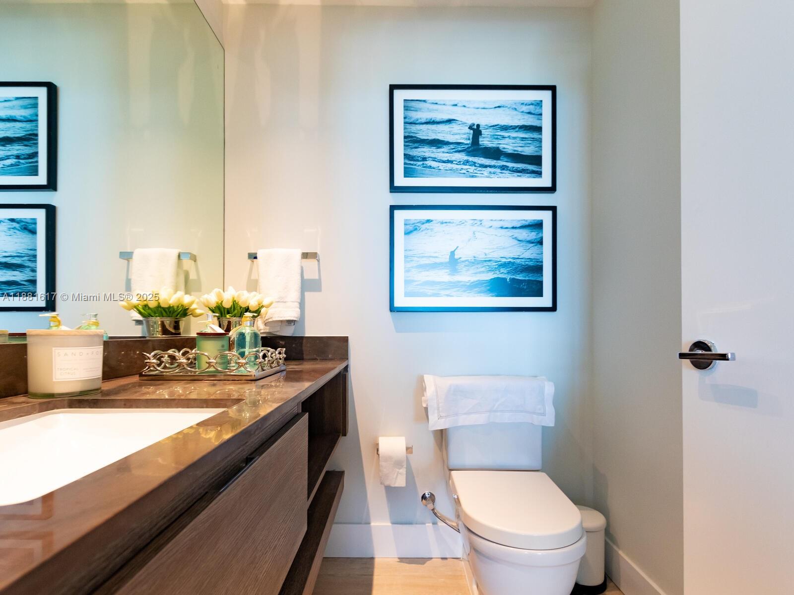 360 Ocean Drive, Unit 304S Key Biscayne, FL 33149 - Photo 35 of 40 a bathroom with a toilet a sink and mirror