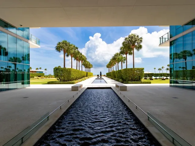 a view of a swimming pool with a yard and plants
