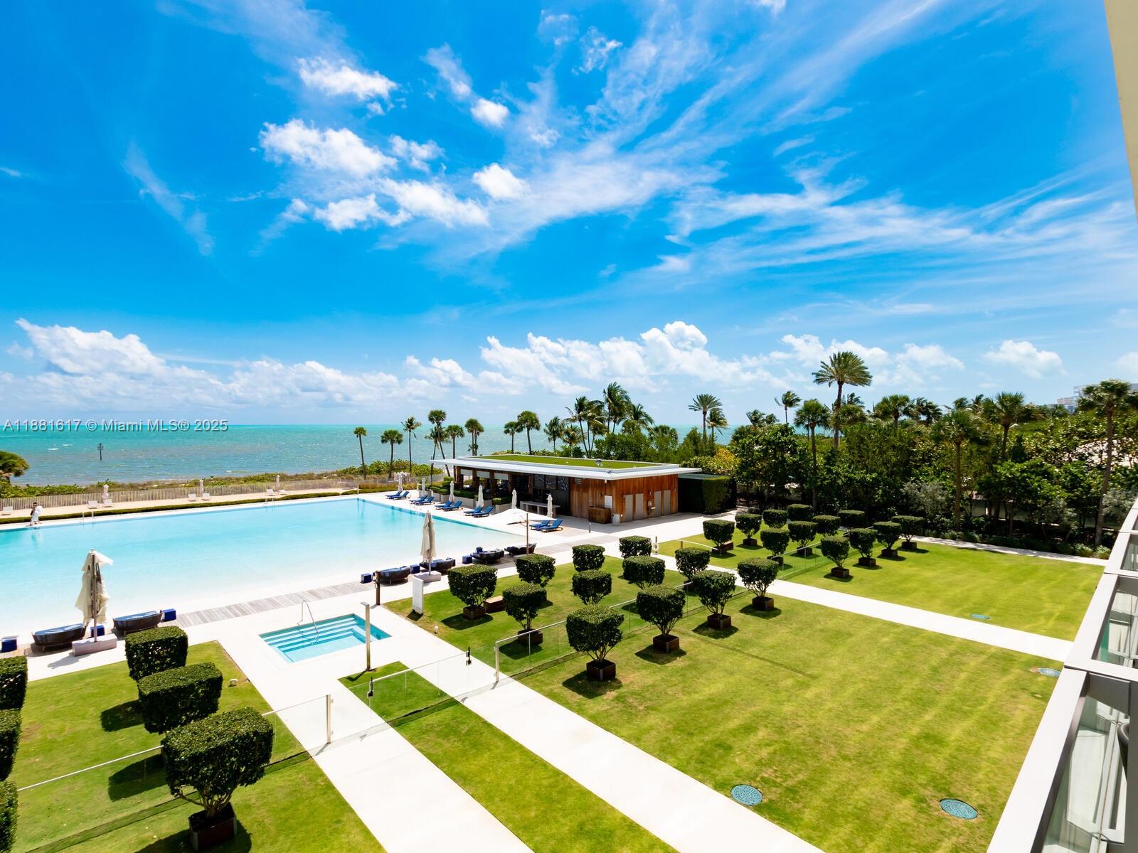 360 Ocean Drive, Unit 304S Key Biscayne, FL 33149 - Photo 4 of 40 a view of a swimming pool with seating area