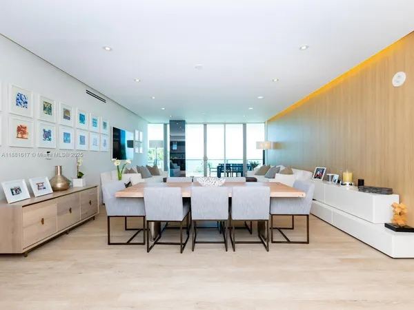 a dining room with furniture and a wooden floor