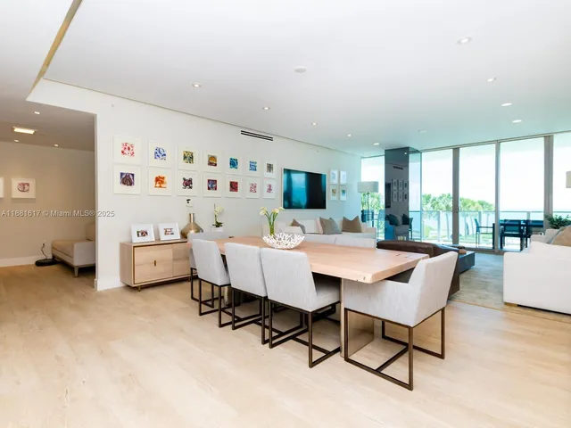 a work room with furniture a large window and a table