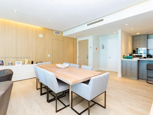 a view of a dining room and a kitchen with a table chairs