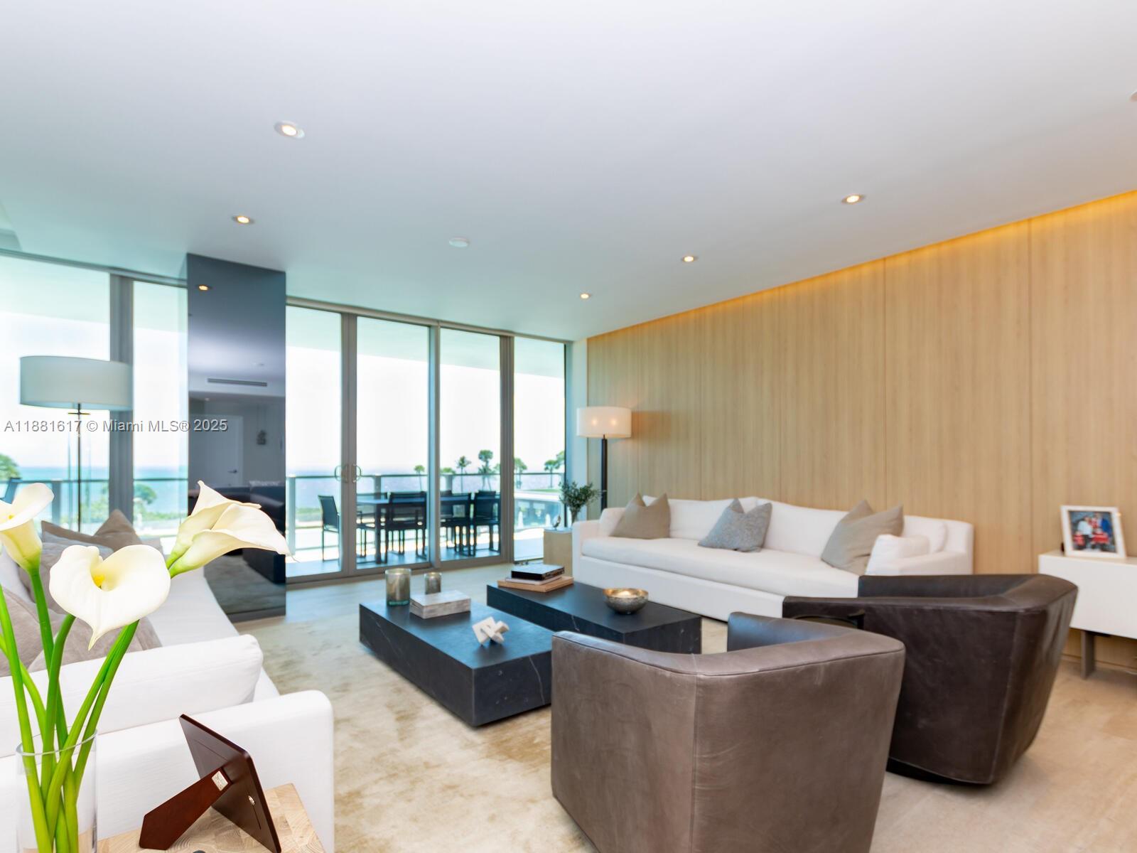 360 Ocean Drive, Unit 304S Key Biscayne, FL 33149 - Photo 9 of 40 a living room with furniture and a large window