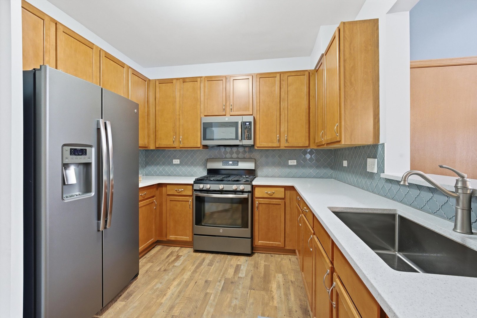 1110 Colonial Drive Joliet, IL 60432 - Photo 14 of 34 a kitchen with stainless steel appliances granite countertop a stove a sink and a refrigerator
