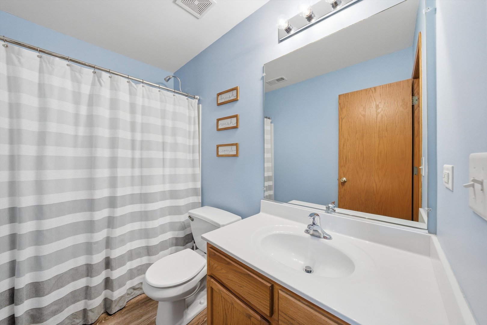 1110 Colonial Drive Joliet, IL 60432 - Photo 22 of 34 a bathroom with a sink a toilet and shower curtain
