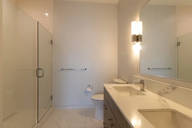 a bathroom with a sink toilet and shower
