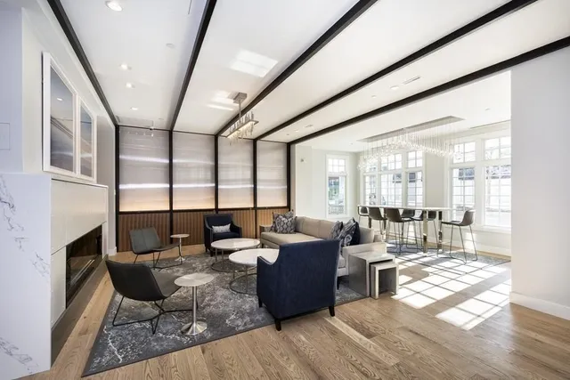 a living room with lots of furniture and a large window