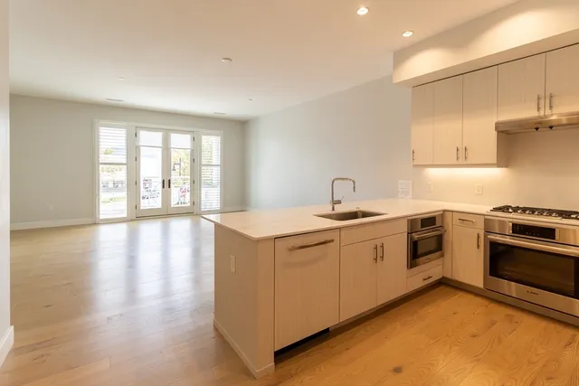 a kitchen with a sink stove and cabinets