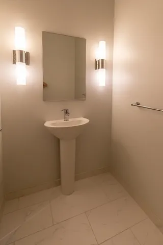 a bathroom with a sink a toilet and mirror