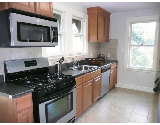 14 Harding Road Lexington, MA 02420 - Photo 5 of 9 a kitchen with stainless steel appliances granite countertop a stove a sink and a microwave