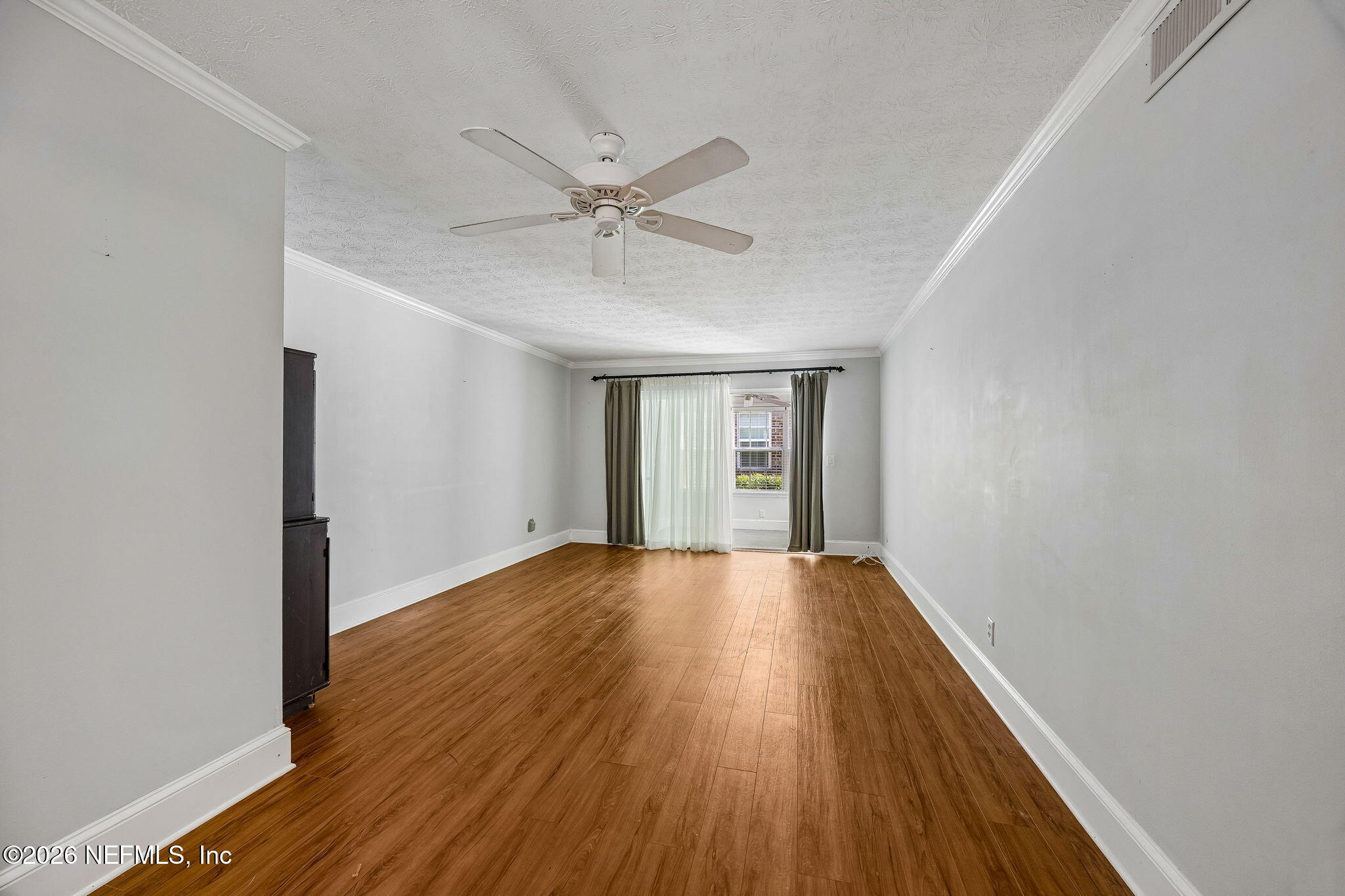 4358 Timuquana Road, Unit 134 Jacksonville, FL 32210 - Photo 2 of 31 a view of an empty room with wooden floor and a window