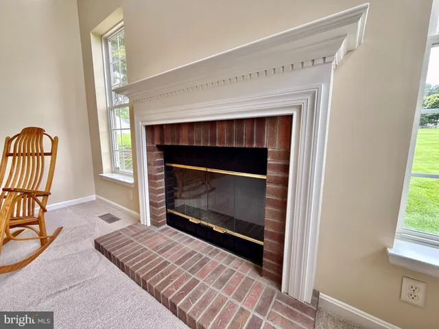 a view of a dining room with furniture and a chandelier