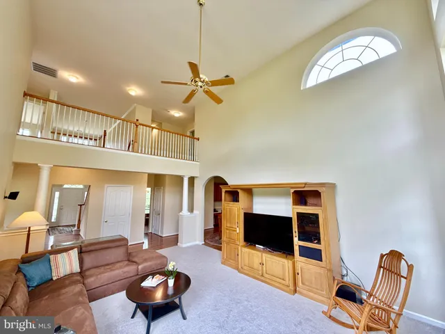 a kitchen with stainless steel appliances granite countertop a refrigerator a stove top oven a sink dishwasher and white cabinets with wooden floor