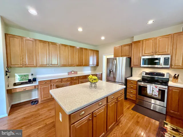 a kitchen with a table chairs sink and cabinets