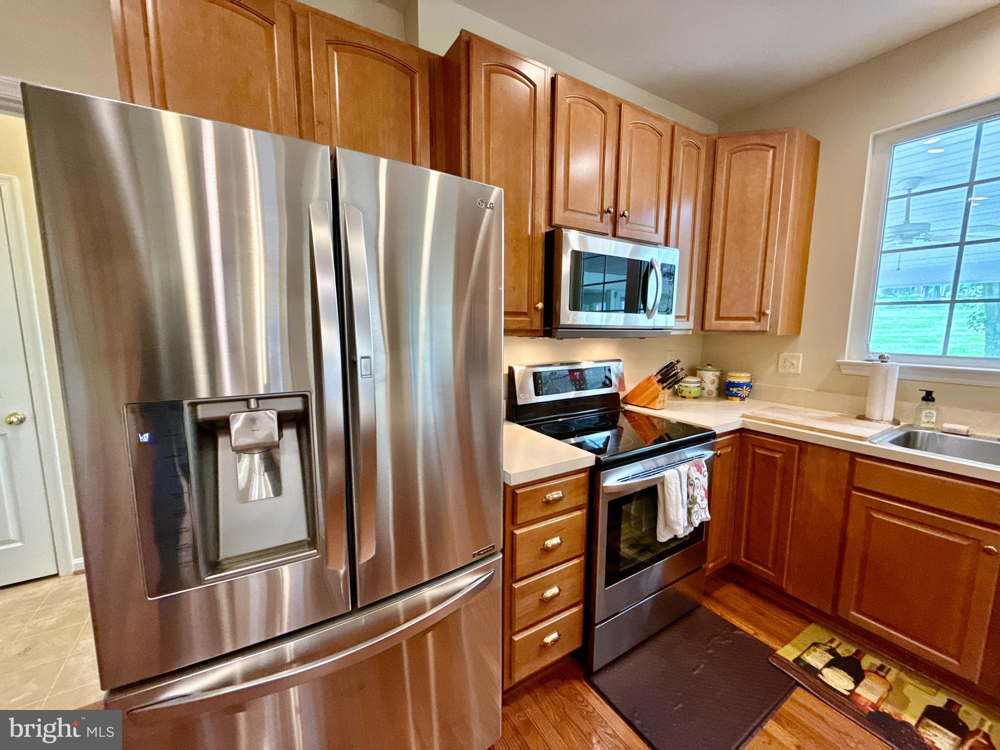 14100 Twisting Lane Dayton, MD 21036 - Photo 23 of 63 a kitchen with stainless steel appliances granite countertop a refrigerator stove and sink
