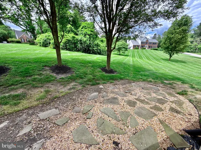a view of a livingroom with wooden floor and stairs