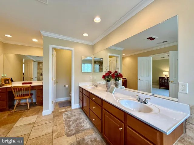a bathroom with a sink vanity and a mirror
