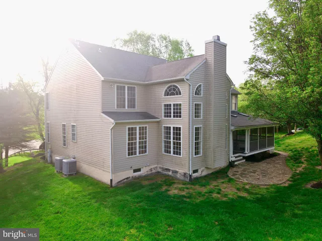 a view of house with a yard and large tree