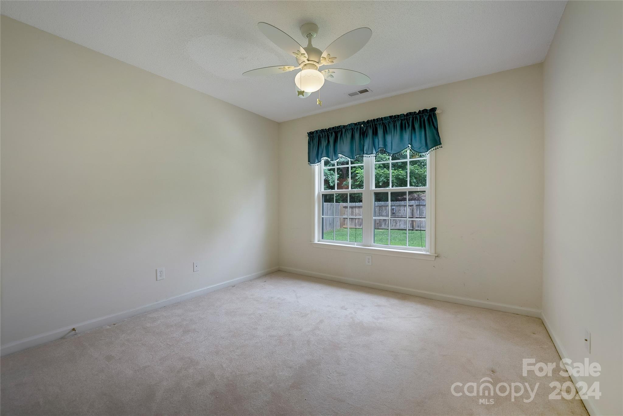 115 English Oak Road Fletcher, NC 28732 - Photo 21 of 30 an empty room with windows and ceiling fan