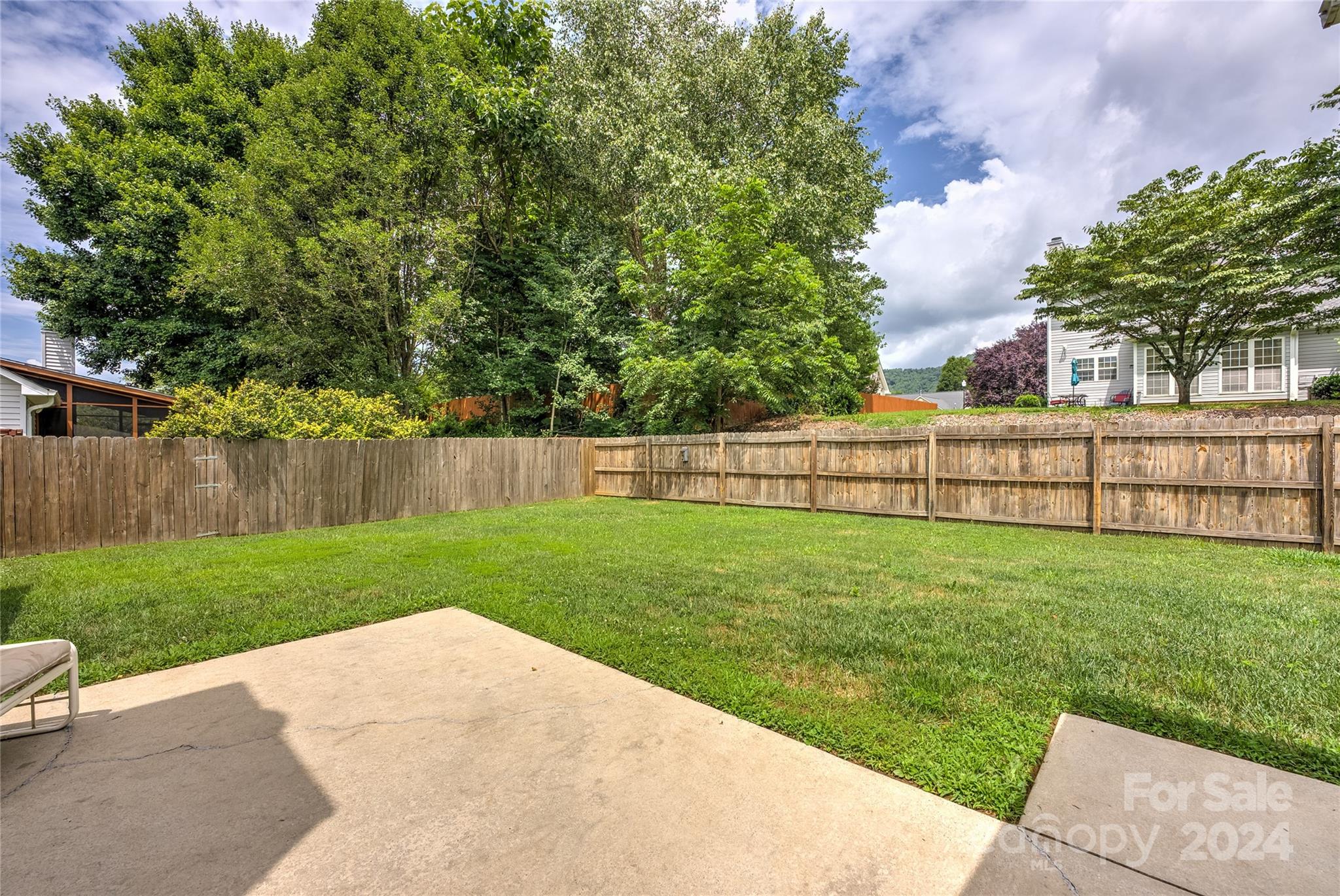 115 English Oak Road Fletcher, NC 28732 - Photo 25 of 30 a view of a backyard with grass & fence