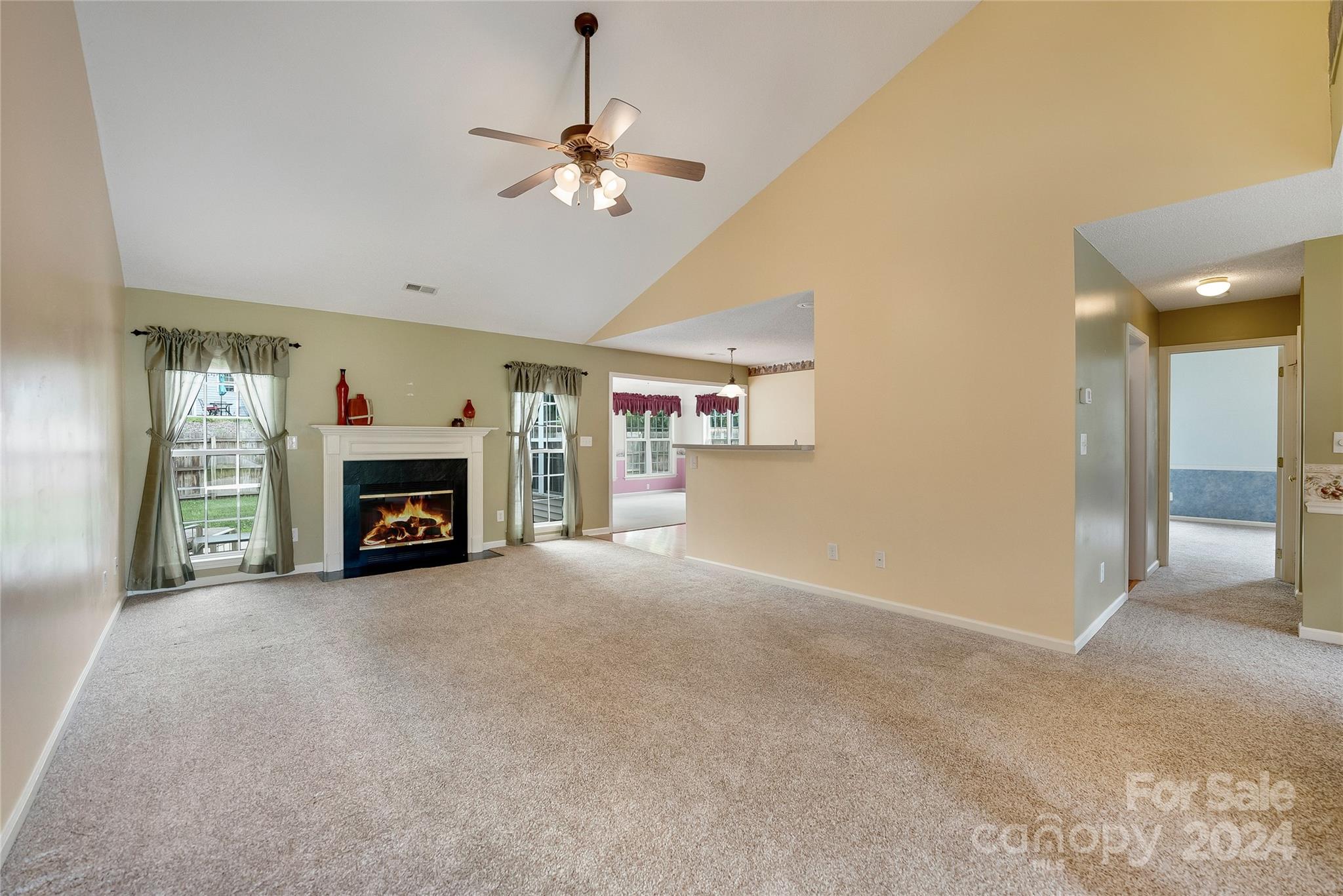 115 English Oak Road Fletcher, NC 28732 - Photo 3 of 30 an empty room with fireplace and chandelier