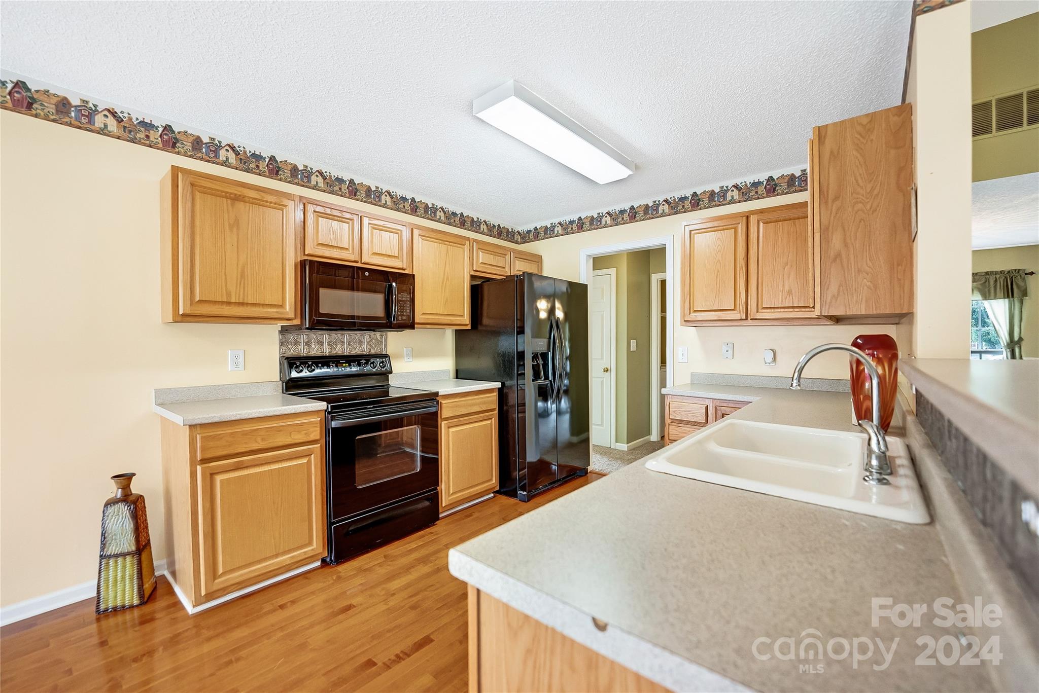 115 English Oak Road Fletcher, NC 28732 - Photo 8 of 30 a large kitchen with stainless steel appliances granite countertop a stove refrigerator and a microwave