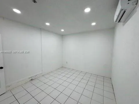 a view of a refrigerator and storage in a room