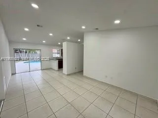 a view of kitchen with stainless steel appliances a refrigerator and a stove top oven