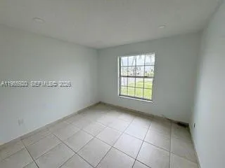 a view of an empty room and a window