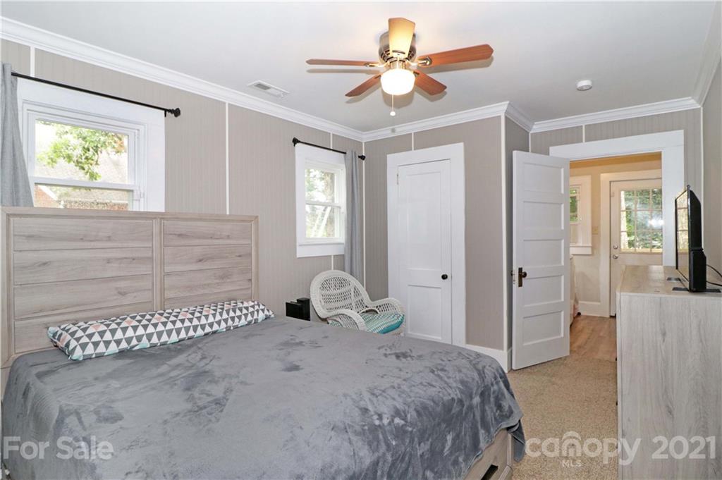 105 Stony Point School Road Stony Point, NC 28678 - Photo 12 of 25 a bedroom with a bed and a chandelier
