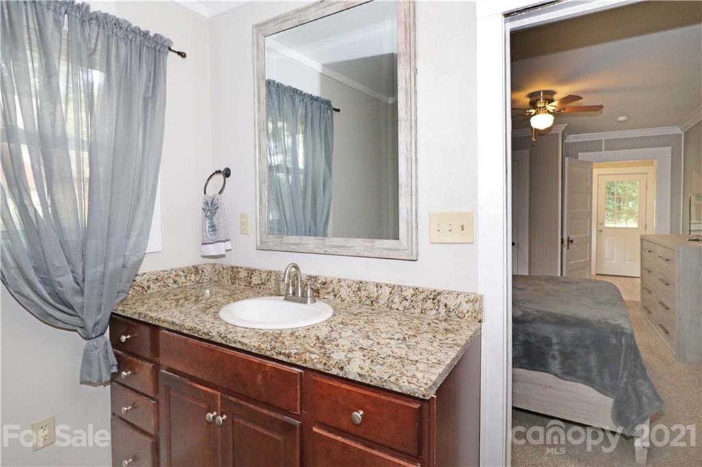 105 Stony Point School Road Stony Point, NC 28678 - Photo 14 of 25 a bathroom with a granite countertop sink and a mirror