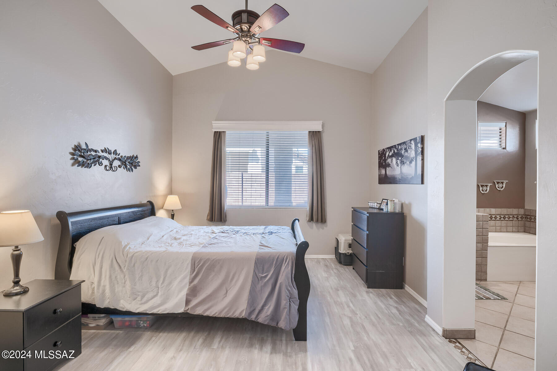 9141 East Dawn Post Road Tucson, AZ 85749 - Photo 13 of 24 a bedroom with a bed and wooden floor