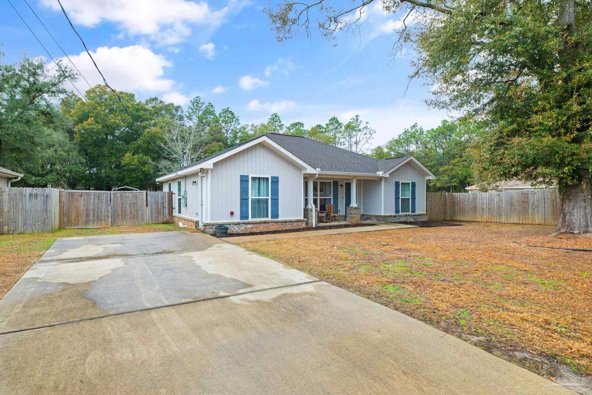 5899 Cedar Tree Drive Milton, FL 32570 - Photo 2 of 29 a house with trees in the background