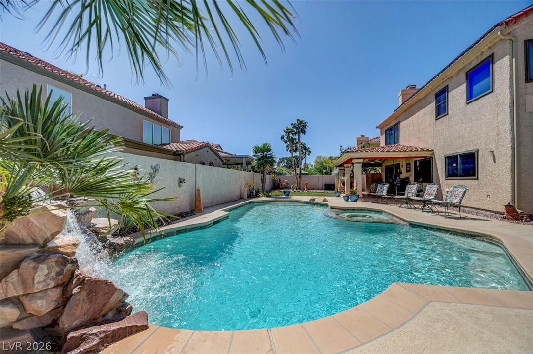 2600 Frontera Road Henderson, NV 89074 - Photo 42 of 47 Refreshing pool/spa area features a flagstone waterfall and notice the stuccoed walls