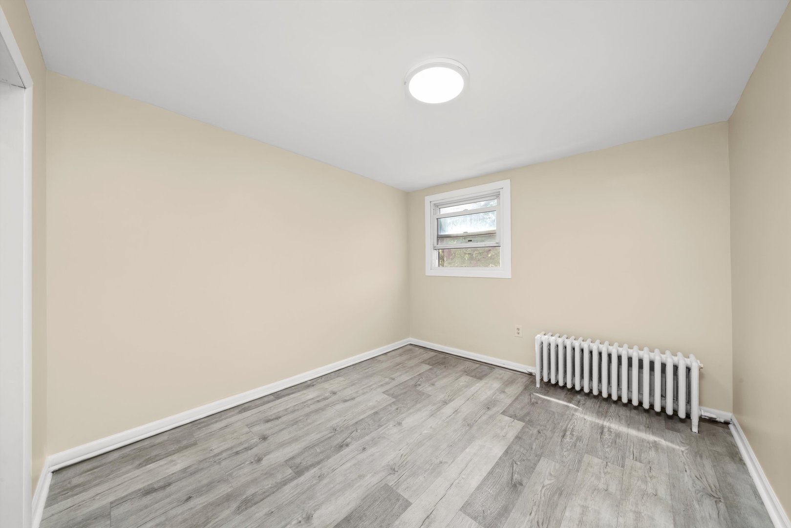 4218 Home Avenue Stickney, IL 60402 - Photo 14 of 35 an empty room with wooden floor and windows