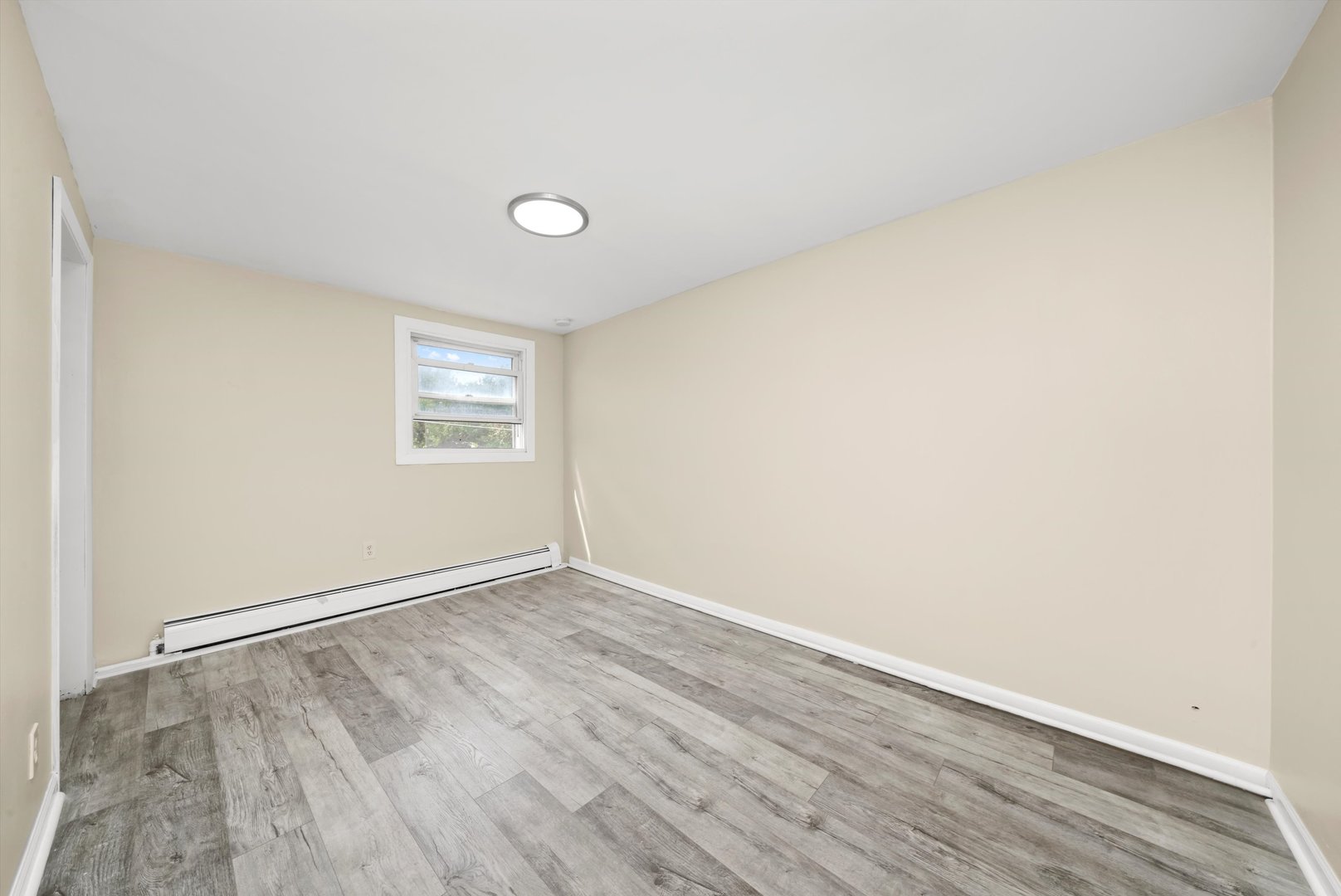 4218 Home Avenue Stickney, IL 60402 - Photo 16 of 35 an empty room with wooden floor and windows