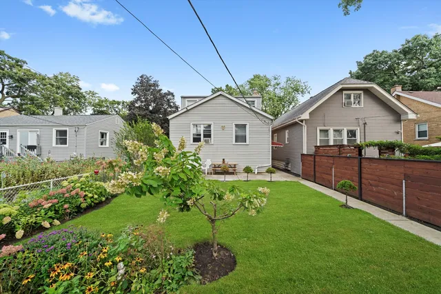 a view of a patio with table and chairs under an umbrella