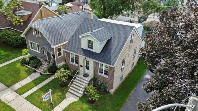 an aerial view of a house with a yard