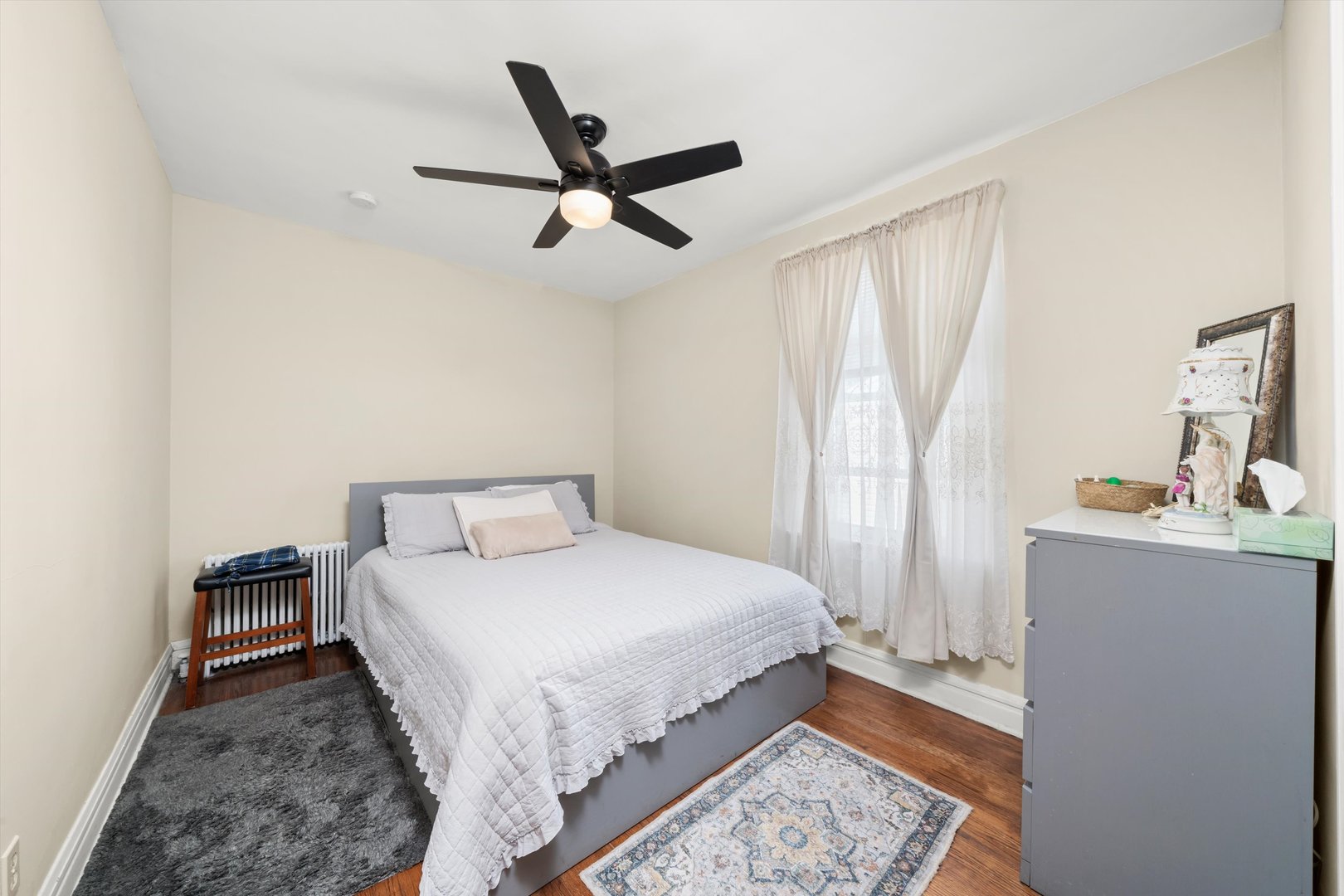 4218 Home Avenue Stickney, IL 60402 - Photo 6 of 35 a bedroom with a bed and a chandelier