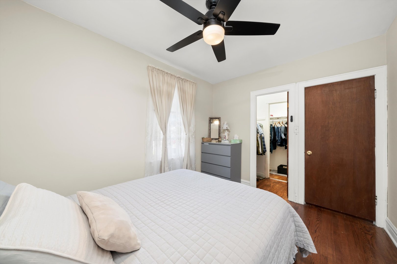 4218 Home Avenue Stickney, IL 60402 - Photo 7 of 35 a bedroom with a bed and a chandelier