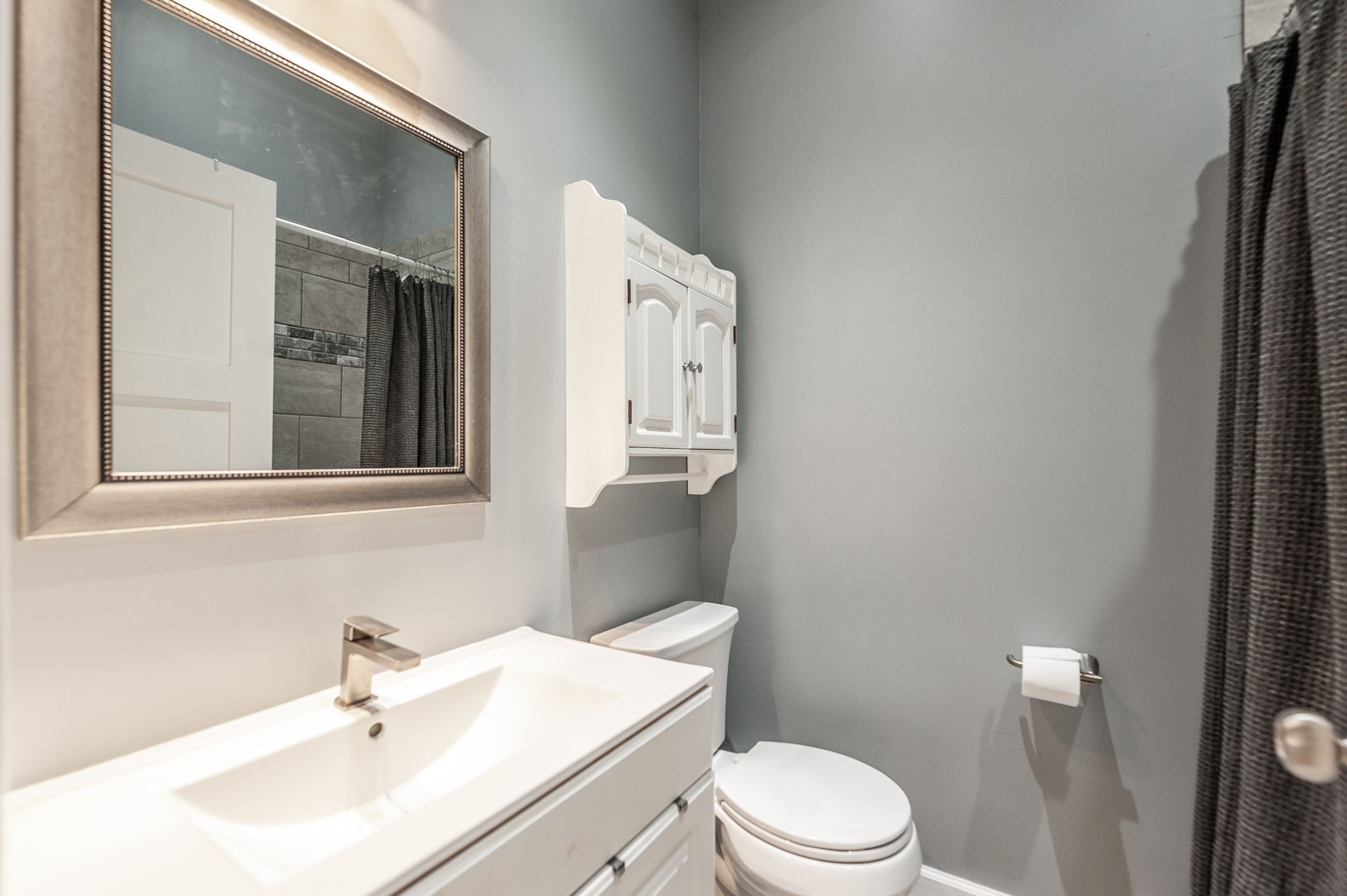8338 Guthrie Road Cross Plains, TN 37049 - Photo 28 of 43 a bathroom with a sink a toilet and mirror