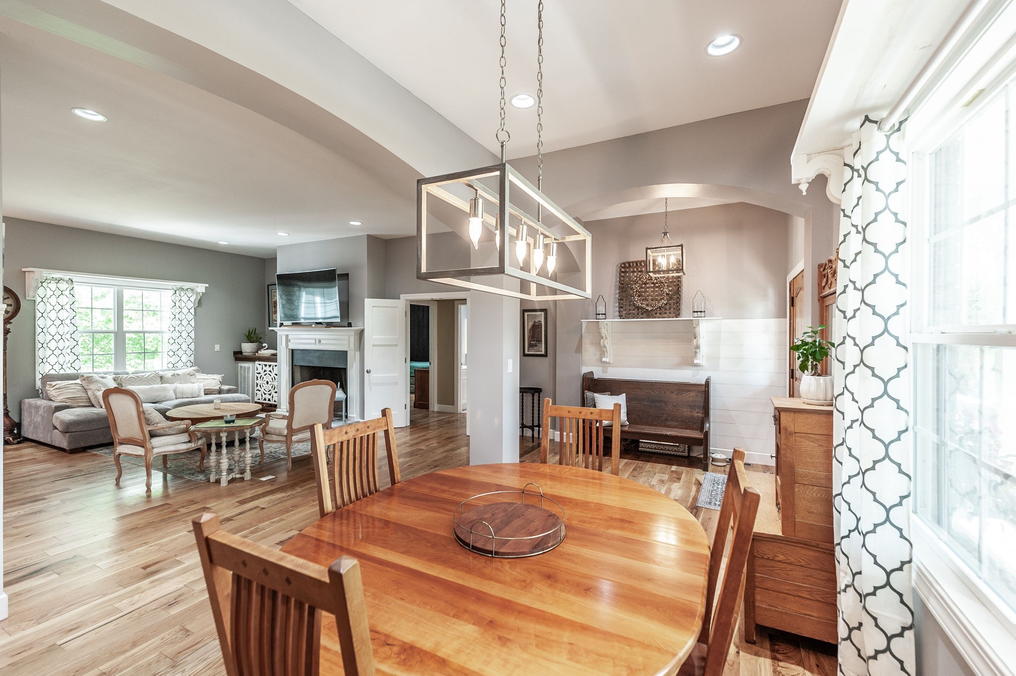 8338 Guthrie Road Cross Plains, TN 37049 - Photo 7 of 43 a dining room with wooden floor a chandelier a wooden table and chairs
