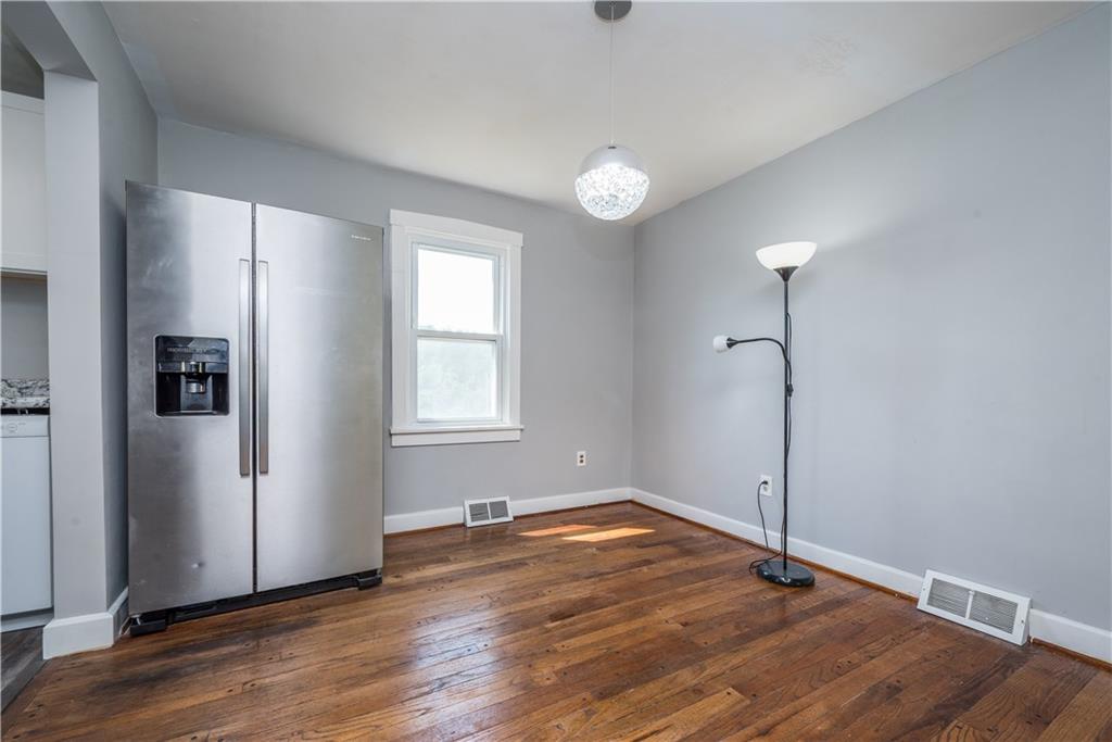 10780 Old Trail Road Irwin, PA 15642 - Photo 13 of 45 an empty room with wooden floor and windows