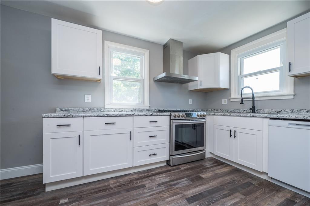10780 Old Trail Road Irwin, PA 15642 - Photo 16 of 45 a kitchen with granite countertop stainless steel appliances white cabinets granite counter tops and a window