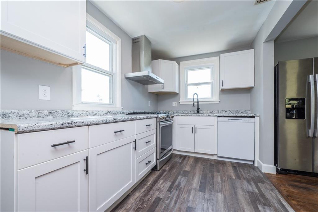 10780 Old Trail Road Irwin, PA 15642 - Photo 19 of 45 a kitchen with granite countertop white cabinets white appliances a sink and a window