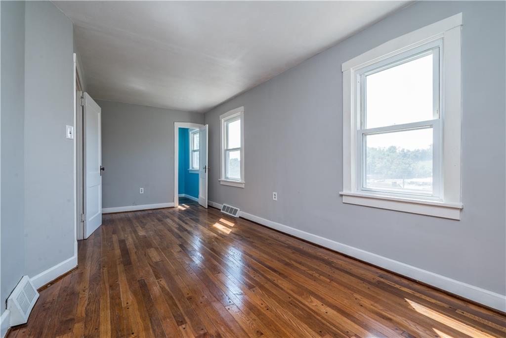 10780 Old Trail Road Irwin, PA 15642 - Photo 28 of 45 a view of an empty room with wooden floor and a window